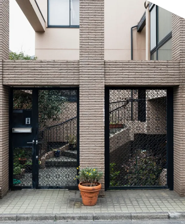 Brick building entrance with potted plant