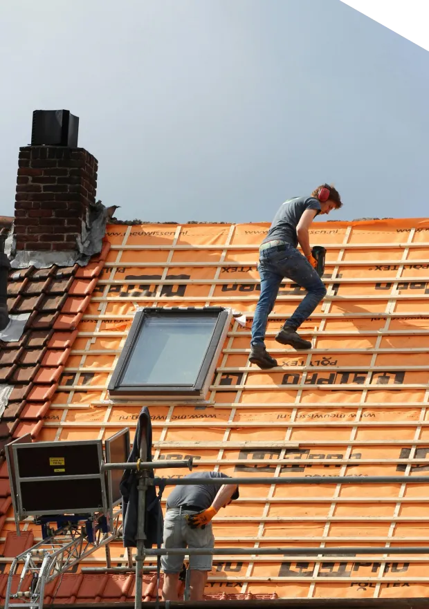 Workers installing solar panels on roof